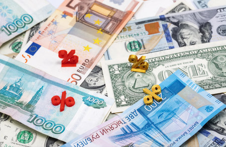 Mathematical symbols of interest lie on top of the banknotesの写真素材