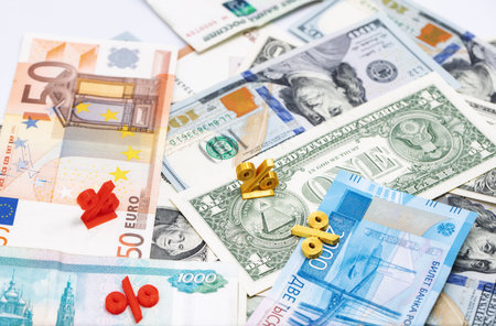 Mathematical symbols of interest lie on top of the banknotesの写真素材