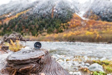 A compass against the background of nature, symbolizing the search for a way and harmony with the outside worldの写真素材