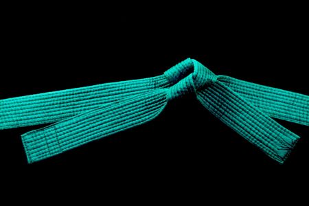 Martial Arts Green Belt over black backgroundの写真素材