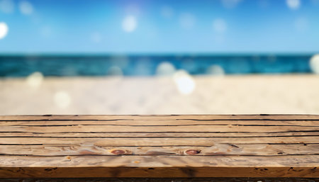Empty wooden table on beach with defocused sea on the background.の素材
