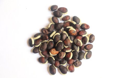 Pile of hyacinth beans scattered on a white background, closeup view