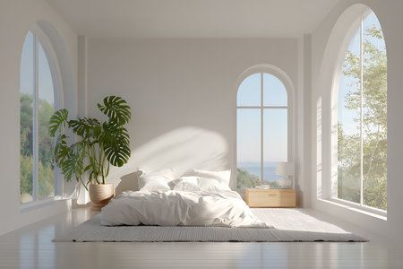 Clean, bright, modern bedroom with white walls and bedding, flooded with natural light from large arched windows revealing an ocean view. A potted monstera plant adds a touch of green.の素材