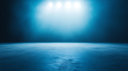 Image displays a dramatic scene with a blue concrete floor, dramatically lit by bright spotlights above. Great for product mockups, stage sets, or technology designs needing depth and light.の素材