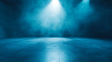 Abstract background of a blue tinted empty room with concrete floor and spotlight in the middle. Thick smoke is visible on the background under spot lighting.の素材
