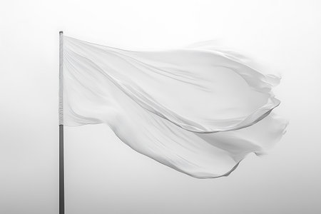 Striking monochrome photograph showcasing a white fabric flag attached to a pole, gracefully waving in the open air. The image evokes a sense of surrender, peace, or minimalist design.の素材