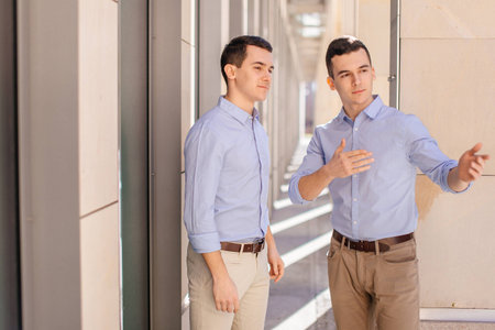 Two businessman talking about business with street city blur backgroundの写真素材