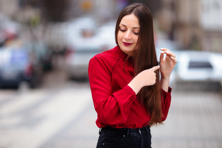 Brunette hair woman brushing her hair with brush and smilingの写真素材