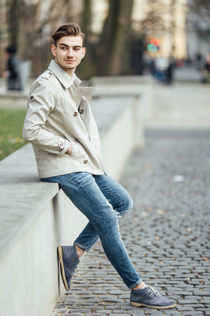 Fashionable man standing outdoors with white backgroundの写真素材