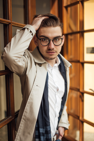 Fashionable man leaving working place, opening doorsの写真素材