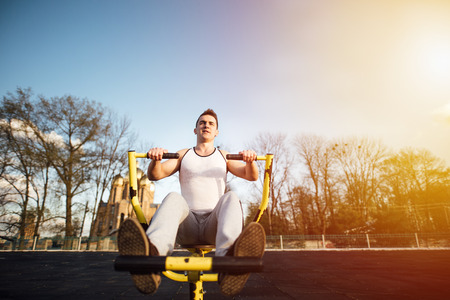 Man do workout at stadium area with sunshine backgroundの写真素材