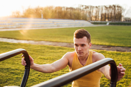 Man do workout at stadium area with sunshine backgroundの写真素材