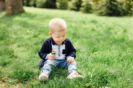 Little boy do bubbles with his mother at park backgroundの写真素材