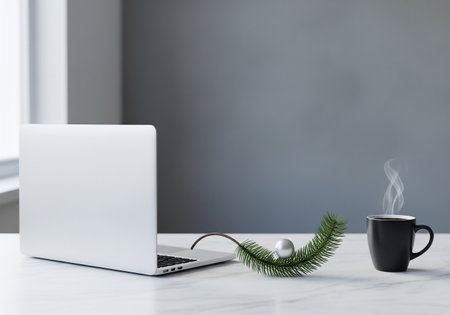 Laptop, coffee cup and christmas tree on white marble tableの素材