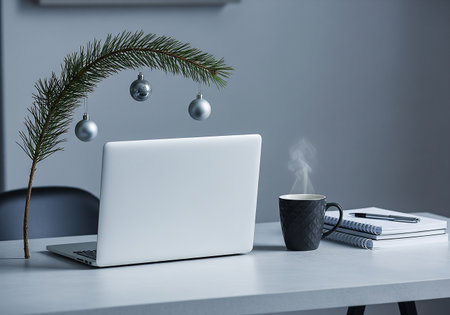Workplace with laptop, coffee cup and christmas decorations on tableの素材