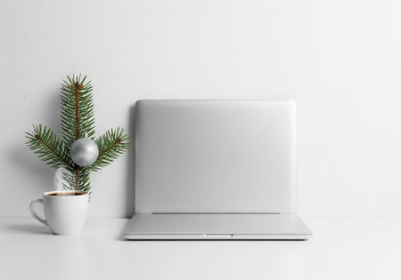 Laptop with coffee cup and christmas tree on the white backgroundの素材
