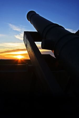 An historical artillery in the sunset scene.の写真素材
