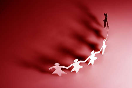 Group of female paper chain representing teamwork.の写真素材