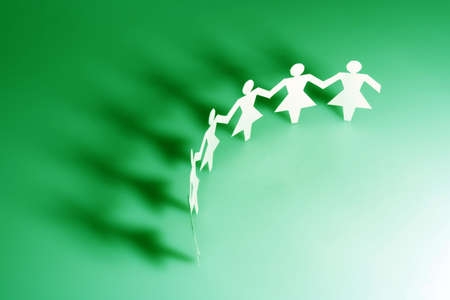 Group of female paper chain representing teamwork.の写真素材