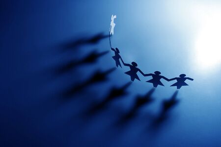 Group of female paper chain representing teamwork.の写真素材