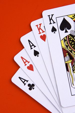 A full house poker game on red background.のeditorial素材