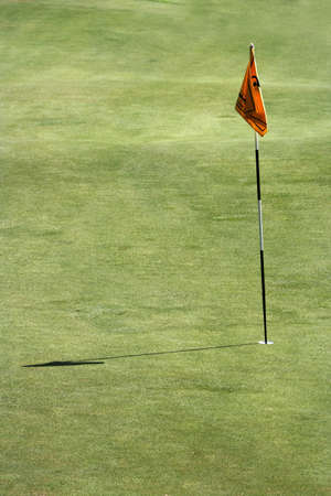 A close up of flag in the golf field .の写真素材