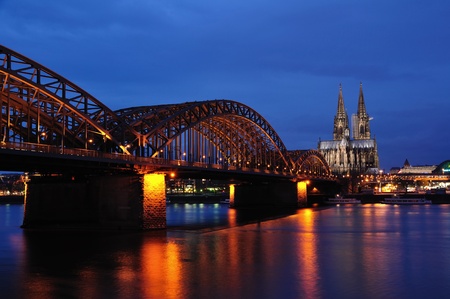 Cologne cathedral with Hohenzollern bridge at nightの写真素材