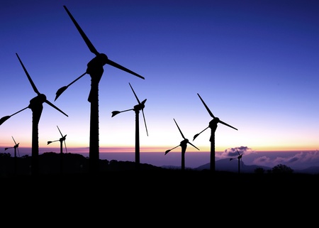 Silhouette of windmills with a sunset