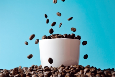 Fresh coffee beans on blue background