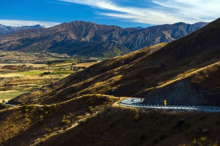 Empty road through mountains in New Zealandの写真素材