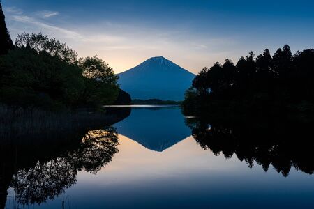 Mountain in sunrise time at Tanuki lakeの写真素材