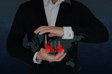 Business man with floating icon show downtrend of petrochemical industrial.の写真素材