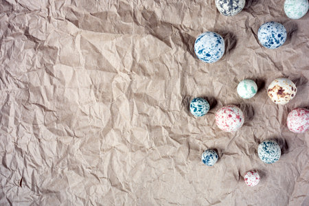 The colorful stone pebble placed on wrinkled brown paper