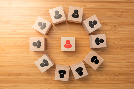 A cube wooden box arrange on wooden surface, teamwork and leader in success business concept.