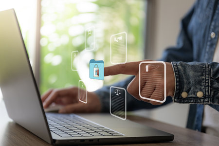 Business man work with laptop seek data folder are locking icon floating on screenの写真素材