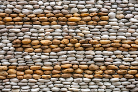Background of small rock which arrange on concrete wallの写真素材