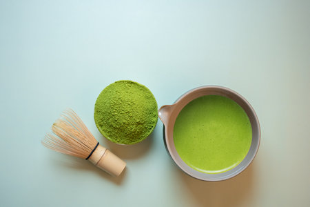 Matcha green tea on a pastel green background, shot in still life style.の写真素材