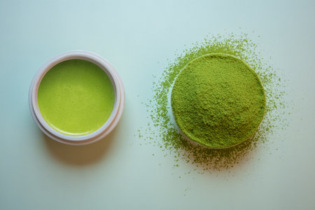 Matcha green tea on a pastel green background, shot in still life style.