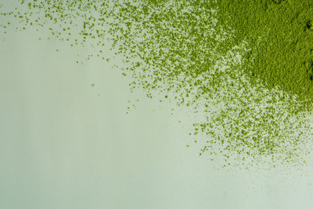 The powder of matcha splash isolate on pastel green background, high quality imageの写真素材