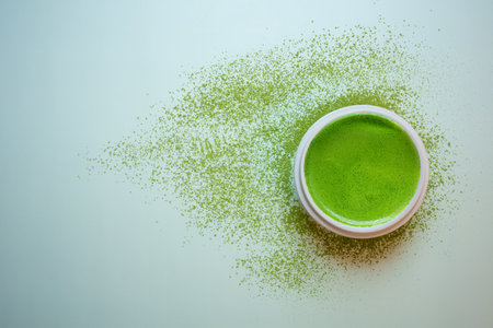 Matcha green tea on a pastel green background, shot in still life style.の写真素材
