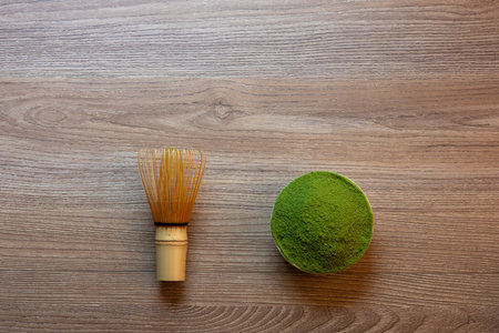 Matcha green tea on a brown wooden table background, shot in still life style.