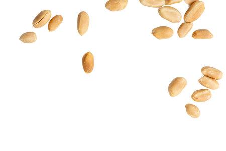 Top view photograph of peanuts scattered on white background.