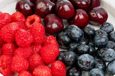 High-resolution fruit photo of cherries, raspberries and blueberries taken with split-focus...