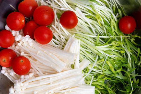 High-resolution photos of ingredients for cooking: tomatoes, golden needle mushrooms, morning glory sproutsの写真素材