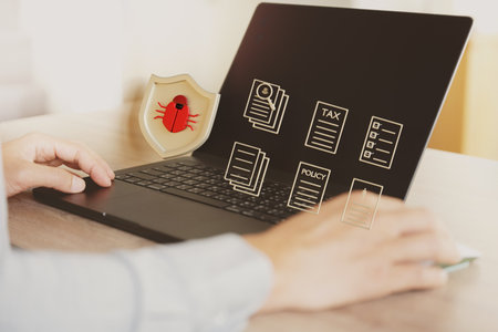 An image that conveys a businessman or employee using an antivirus or anti-malware program to protect business data.の写真素材