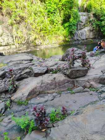 Unidentified tourists relax and take photos at the waterfalls.の写真素材