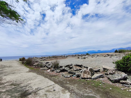 The coast of the island, under a blue sky with white cloudsの写真素材