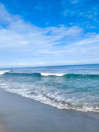beach and tropical sea under blue skyの写真素材