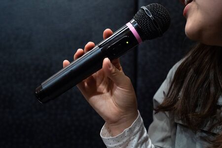 Image of a woman who sings in karaokeの写真素材