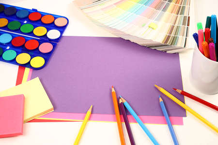 Colored paper colored pencils paint palette and brushesの写真素材